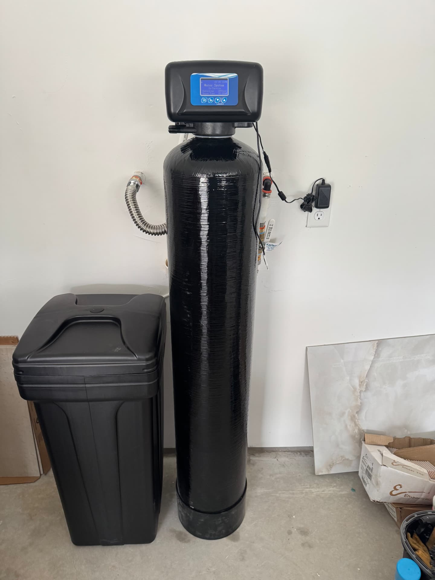 Water softener and brine tank installed in a garage