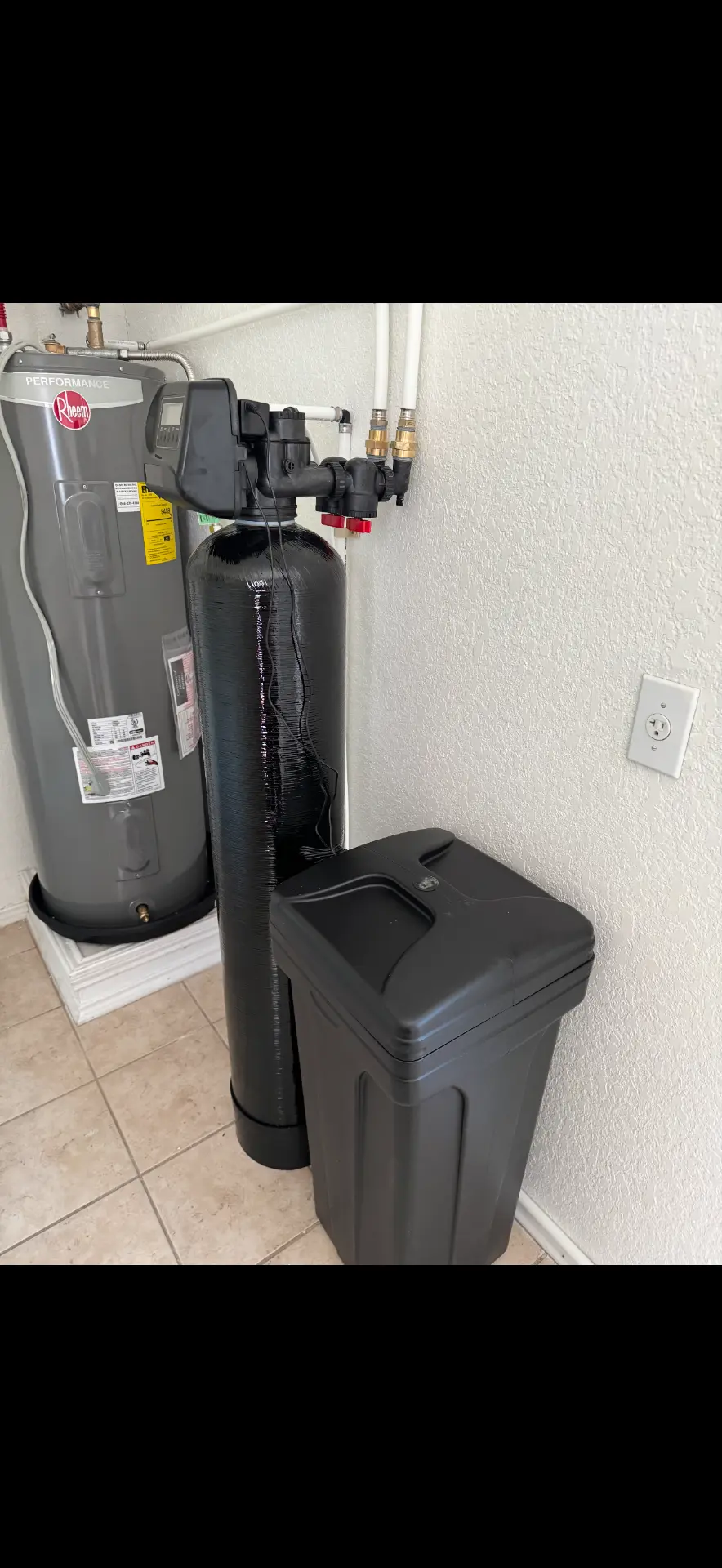 Water softener installed beside a water heater